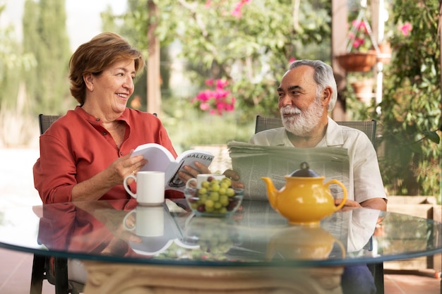 Free photo elderly couple enjoying life at home in the countryside