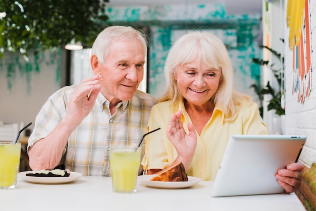 Elderly couple having video call on tablet