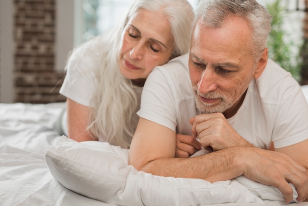 Elderly couple laid in bed on valentines day