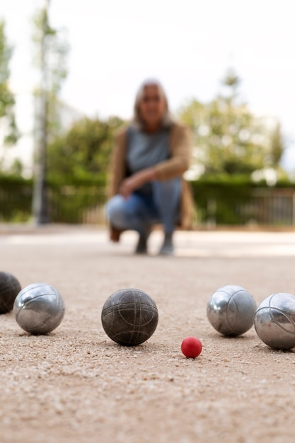 Elderly friends playing petanque