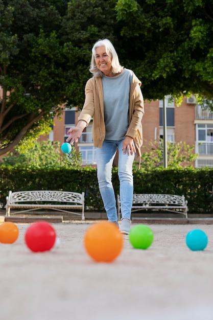 Free photo elderly friends playing petanque