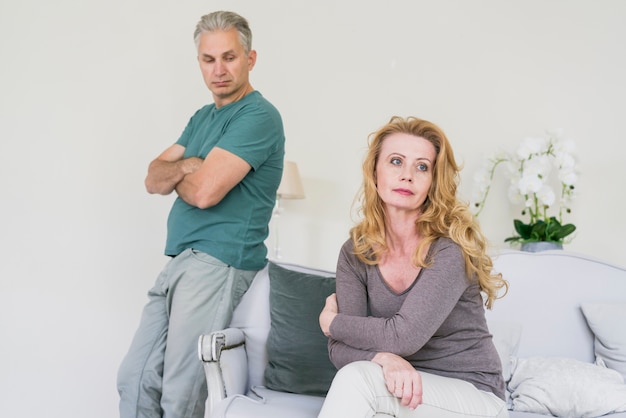 Elderly husband and wife at home worried