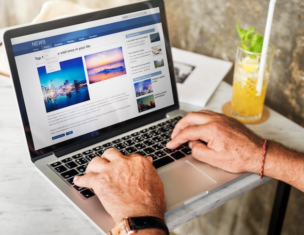 Free photo elderly man is using computer laptop