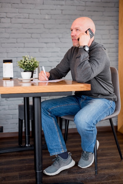 Elderly man talking by telephone