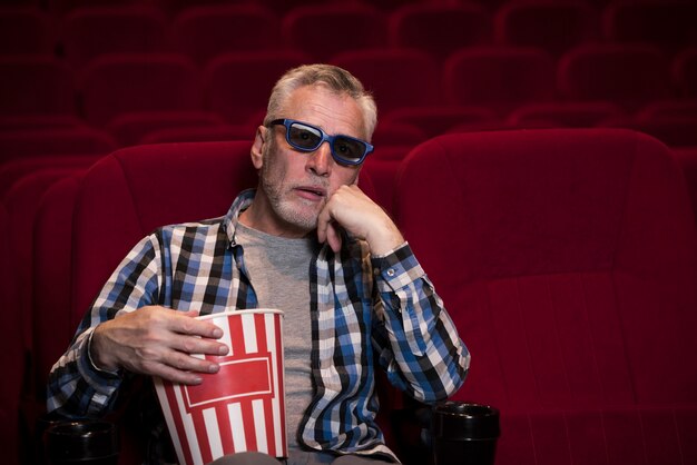 Elderly man watching movie in cinema