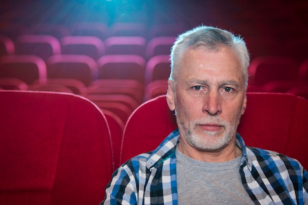 Elderly man watching movie in cinema