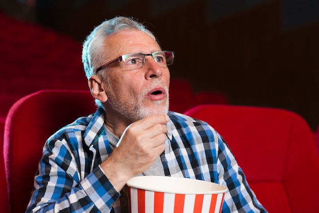 Elderly man watching movie in cinema