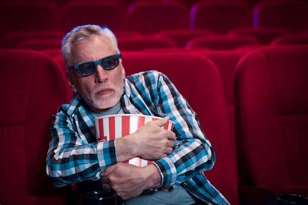 Elderly man watching movie in cinema