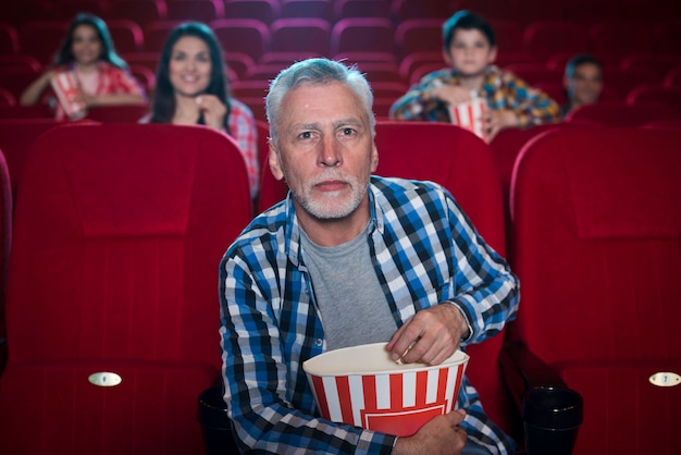 Elderly man watching movie in cinema