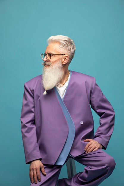 Elderly man with chain necklaces posing