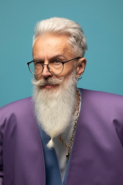 Elderly man with chain necklaces posing