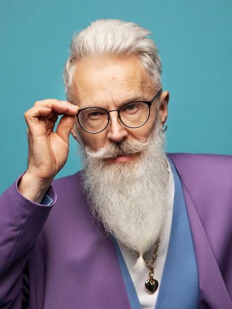 Elderly man with chain necklaces posing