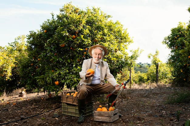 Elderly man with fresh oranges