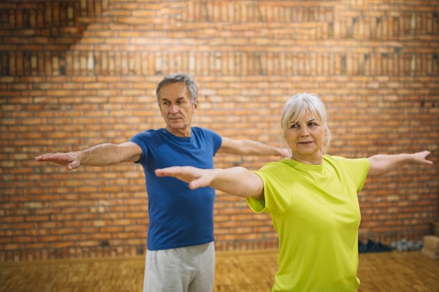 Free Photo elderly people doing balance exercise