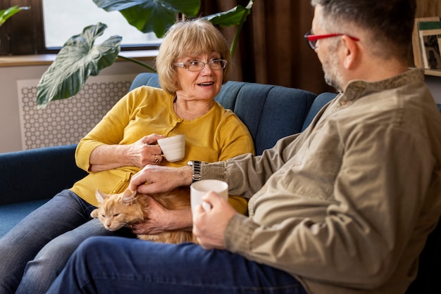 Free photo elderly people with cat pet