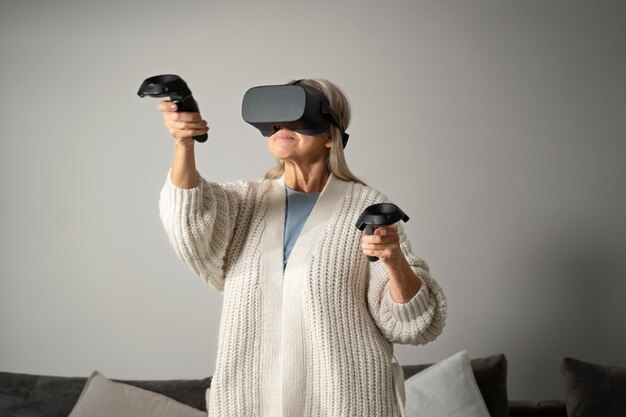 Elderly person using vr set for game immersion