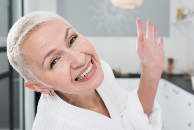 Free Photo elderly woman posing and smiling wide