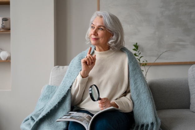 Free Photo elderly woman reading using a magnifying glass to read