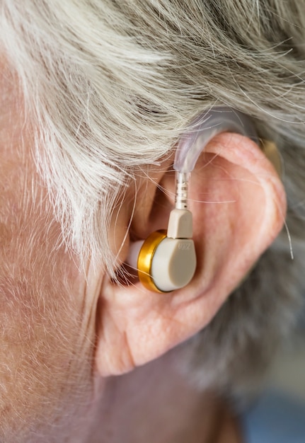 Elderly woman wearing a hearing aid