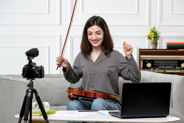 Free Photo elearning cute young beautiful girl remotely at home giving violin classes very happy