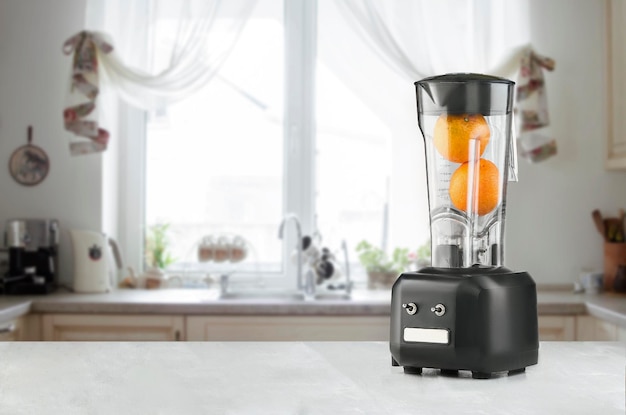 Free photo the electric blender for make fruit juice or smoothie on the kitchen table. the concept of a healthy diet