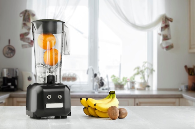 The electric blender for make fruit juice or smoothie on wooden kitchen table. The concept of a healthy diet.