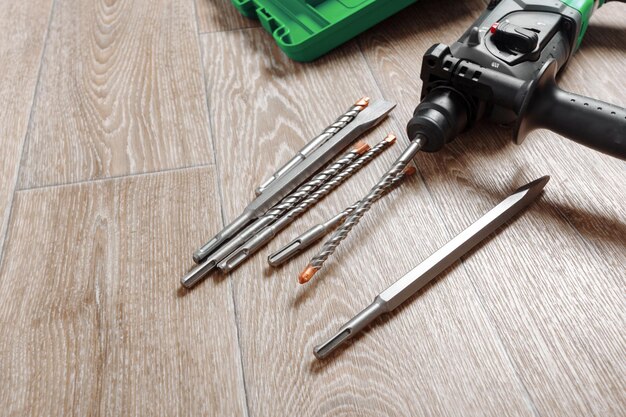 Free Photo electric hammer drill lies on a wooden table