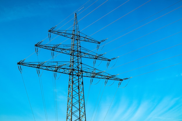 Free photo electrical pole with a blue sky in the background