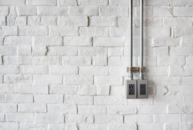 Free Photo electrical socket on a white painted brick wall