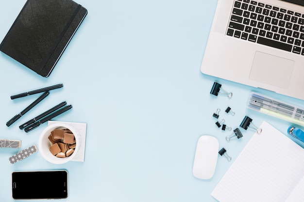 Electronic devices and stationeries on blue backdrop