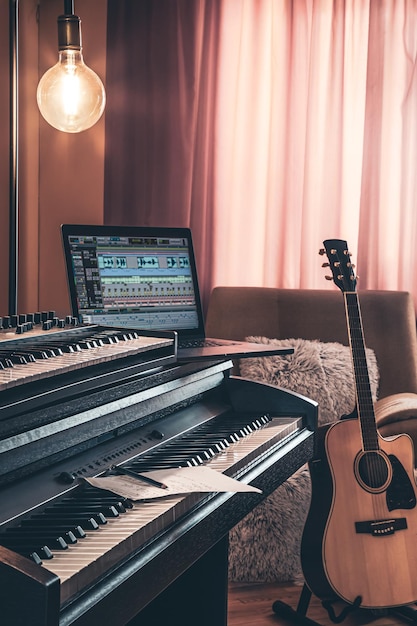 Electronic piano and guitar in room interior