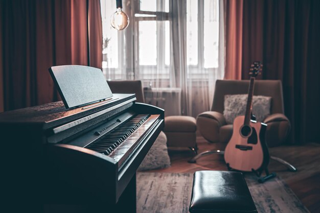 Electronic piano in the interior of the room on a blurred background