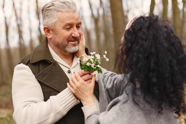 Free photo elegant adult couple in a spring forest