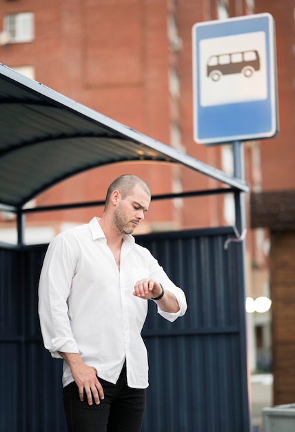 Free photo elegant adult male waiting for the bus