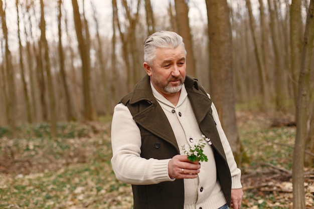 Free Photo elegant adult man in a spring forest