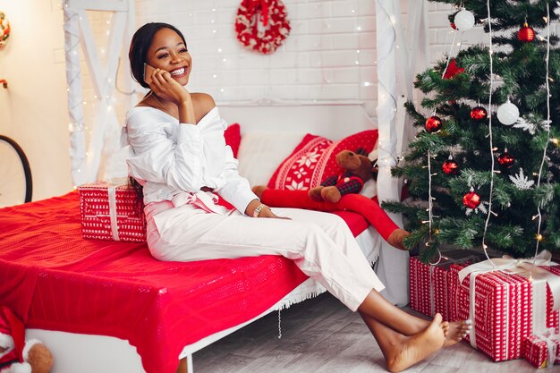 Elegant black girl in the Christmas decorations