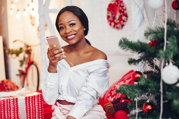 Elegant black girl in the Christmas decorations