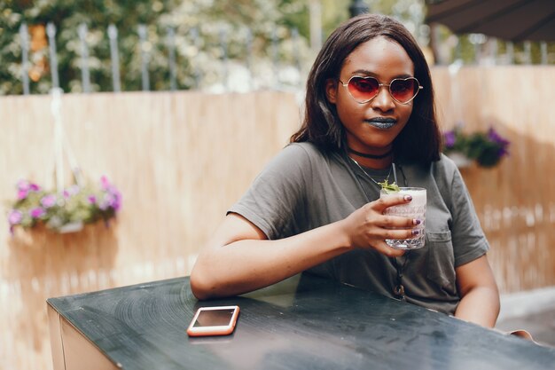 Elegant black girl in a summer city