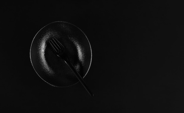 Free Photo elegant black plate in the japanese style with fork table setting flat lay black background minimalist breakfast idea in black color