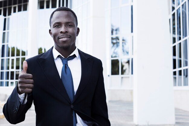 Elegant businessman with thumbs up