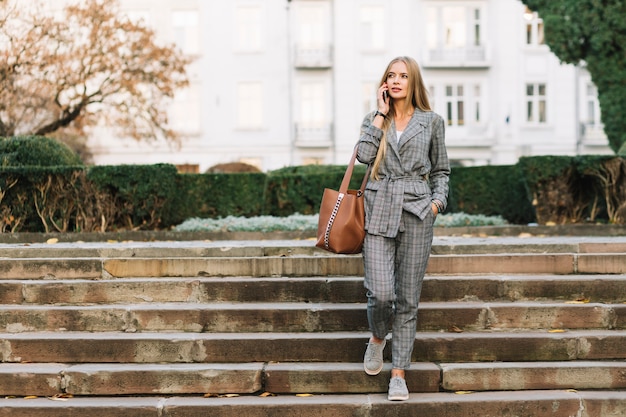 Elegant businesswoman making phone call in city