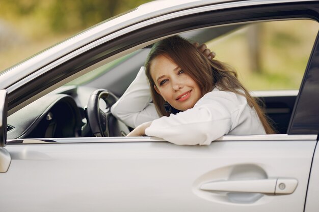 Elegant businesswoman sitting in a car