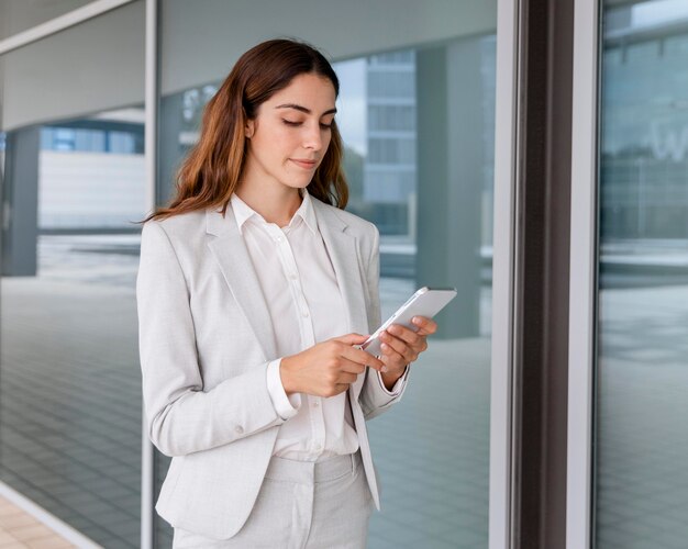 Elegant businesswoman using smartphone outdoors