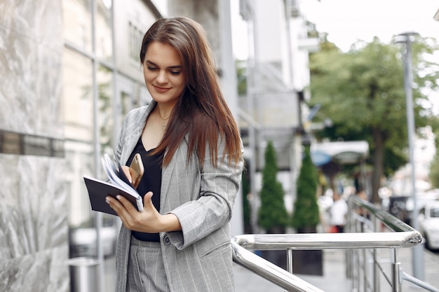 Elegant businesswoman working in a city and use the notebook