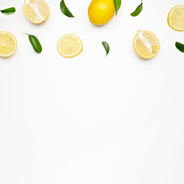 Free photo elegant composition of set of lemons on a white surface