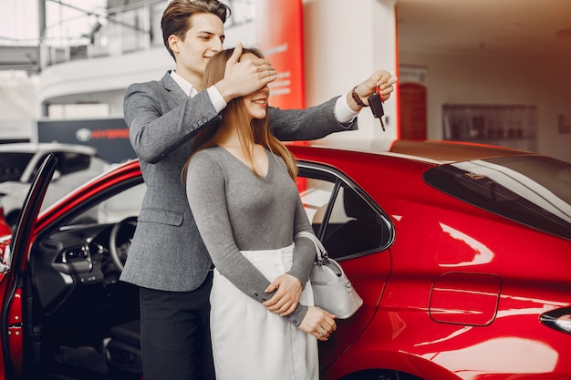 Elegant couple in a car salon