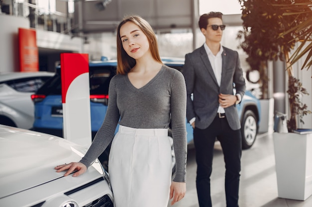 Elegant couple in a car salon