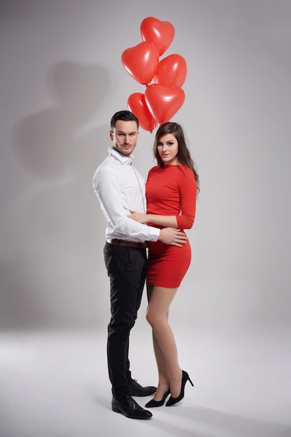 elegant couple posing with balloons