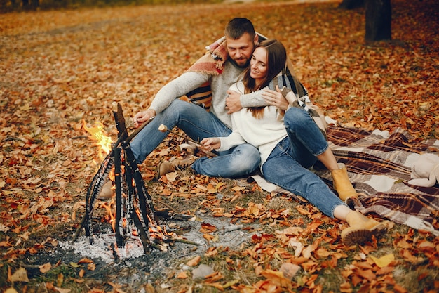 Elegant couple spend time in a autumn park