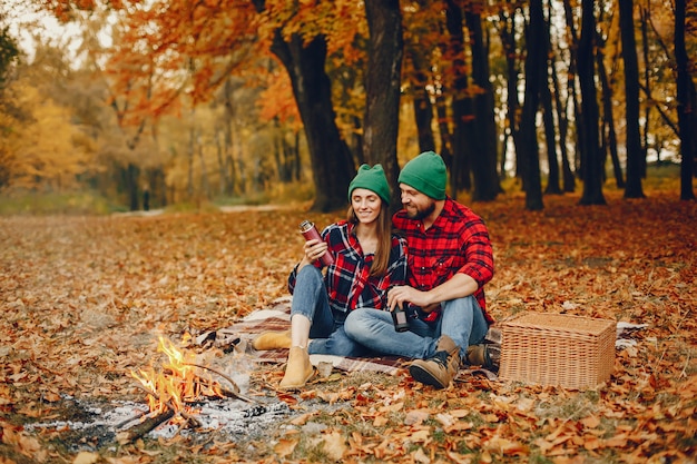 Elegant couple spend time in a autumn park